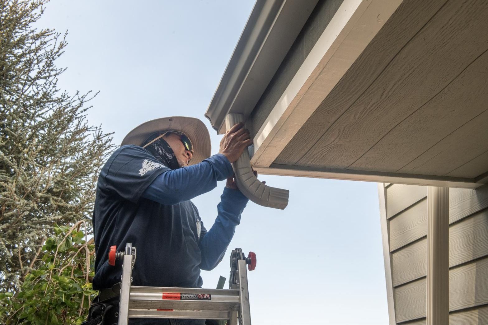 Attaching a downspout at the eave on an Irvine job