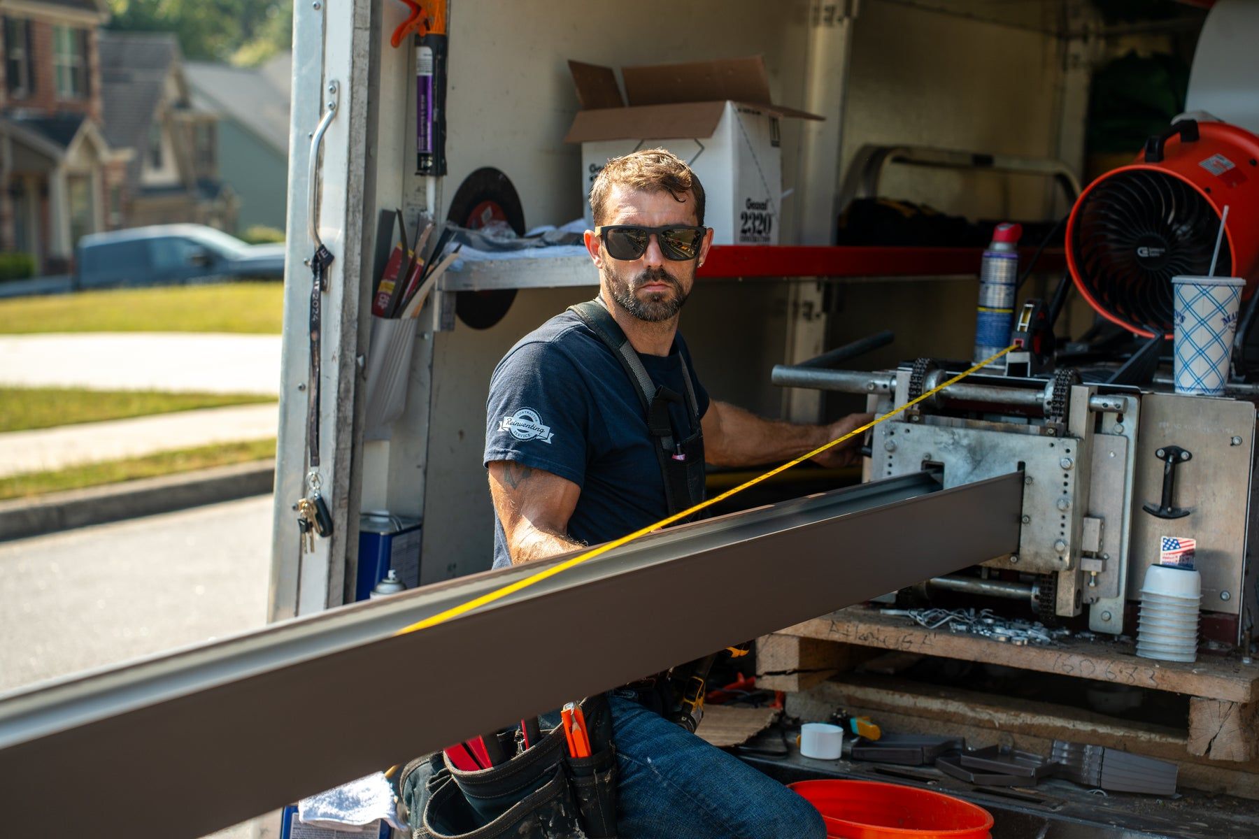 Installer forming a seamless gutter inside the truck