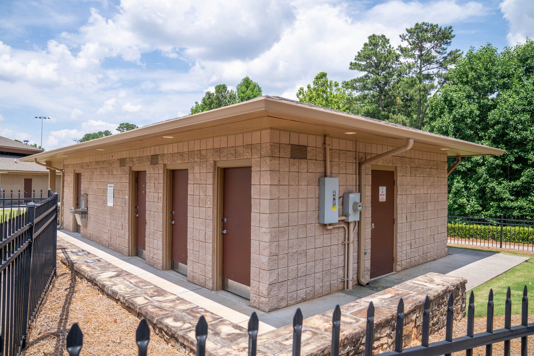 Seamless gutters and downspouts on a block commercial building