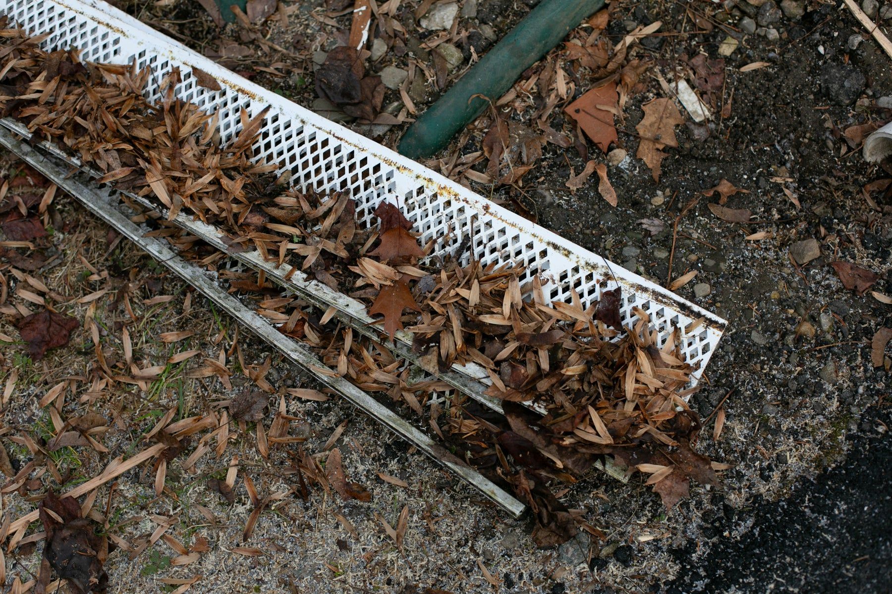 Old plastic leaf guards pulled off and full of debris